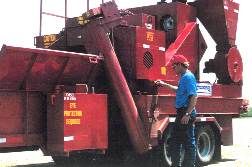 Fred Peltz with early rotochopper horizontal grinder