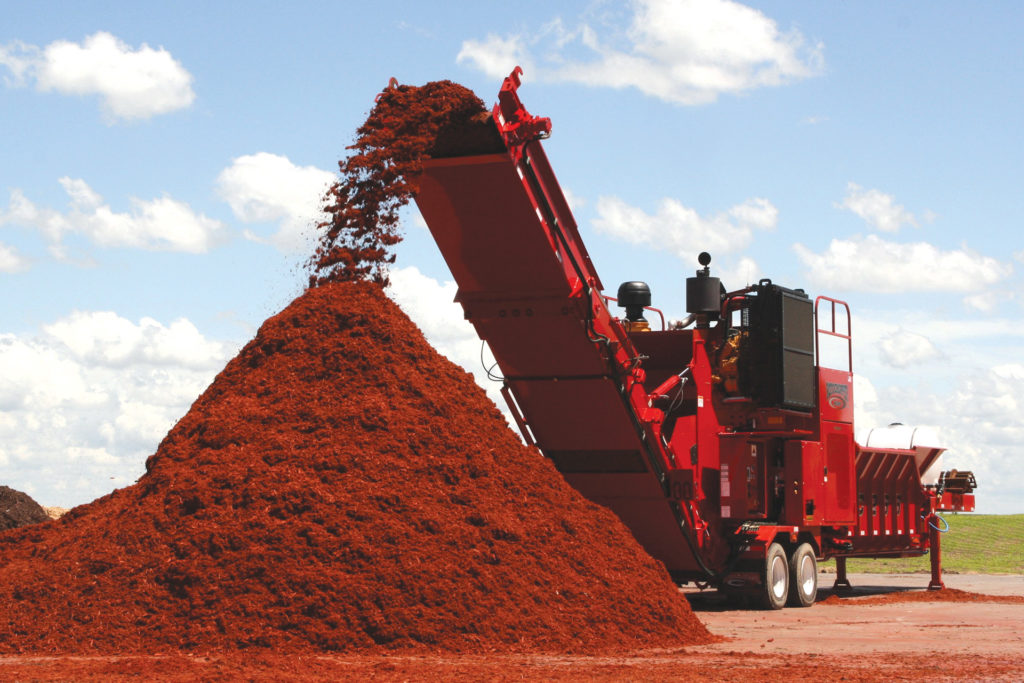 mc266 diesel horizontal grinder red colored mulch pile