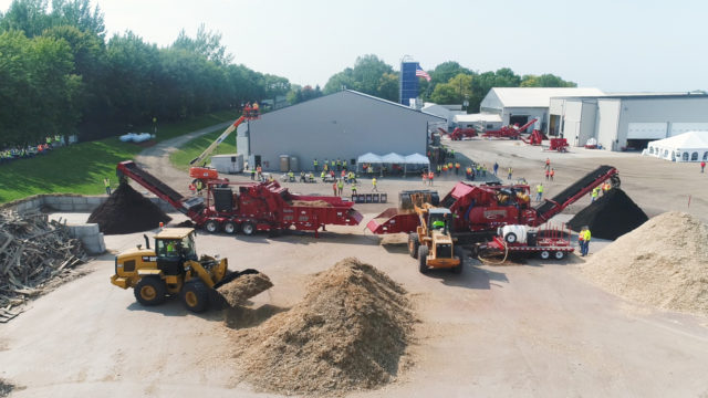 Multiple horizontal grinders processing colored mulch at Demo Day 2017.