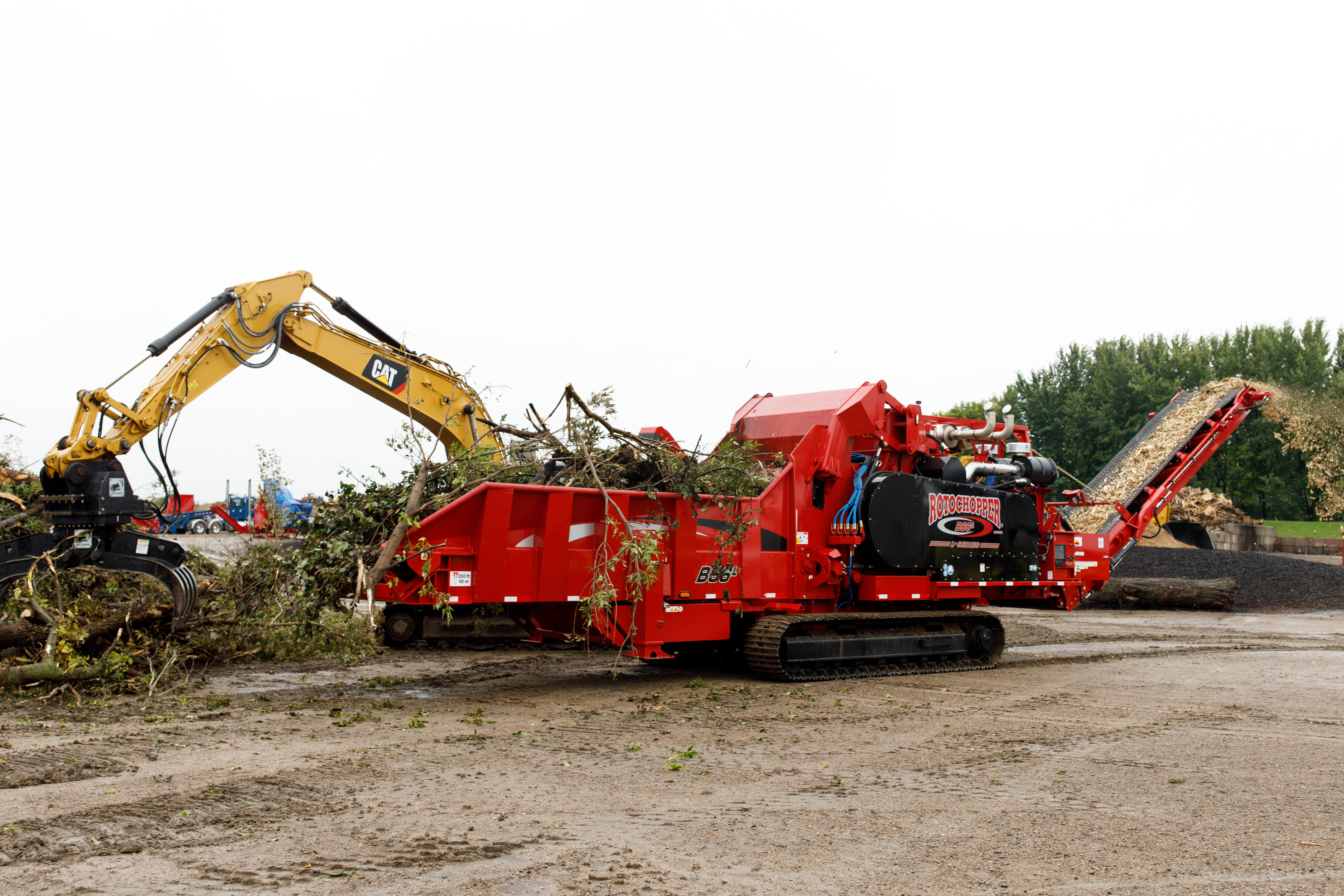 A large grinding machine demonstrates how easily it can grind trees into tiny pieces during Rotochopper's demo day event.