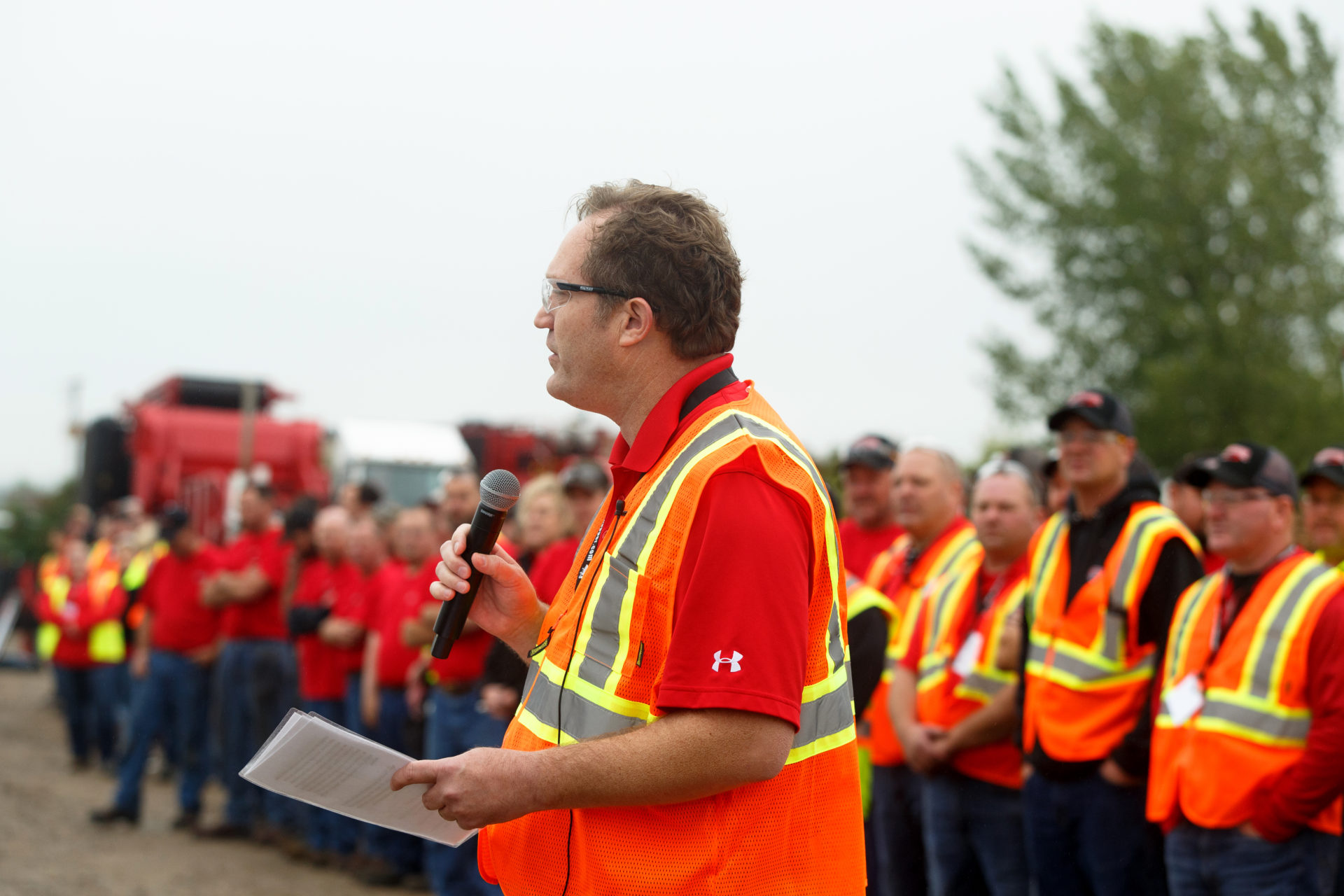 Rotochopper CEO with a microphone speaking to the crowd at the annual demo day event held by Rotochopper.