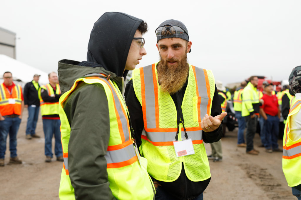 Men with vests and safety equipment are gathered around for one of Rotochopper's Demo Day events in MN.