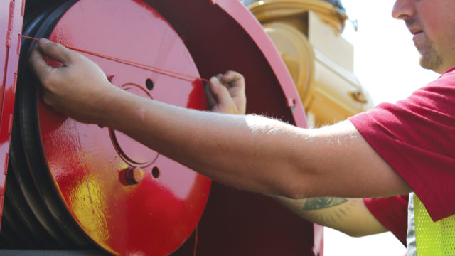 A Rotochopper service technician servicing a horizontal grinder.