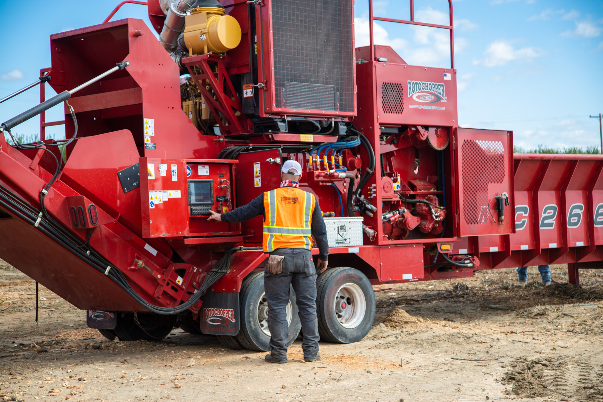 Two Rotochopper service technicians performing maintenance on a horizontal grinder.