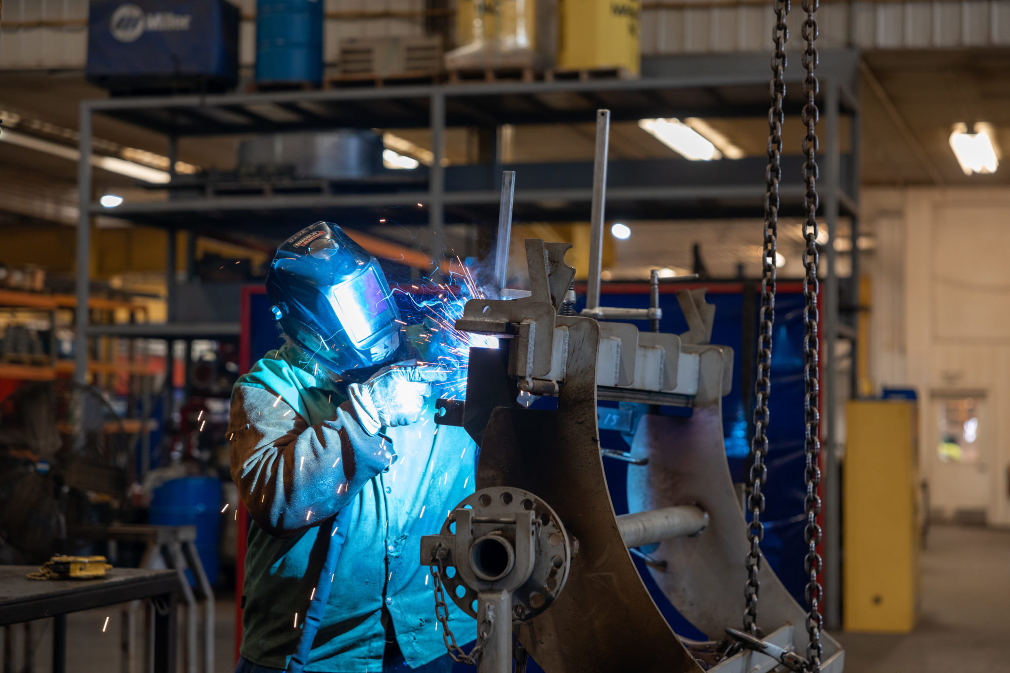 A Rotochopper welder working on a piece of horizontal grinder machinery.