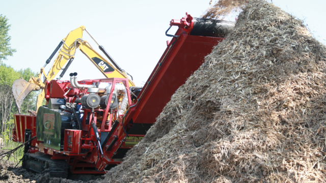 Rotochopper land clearing horizontal grinder grinding wood waste.