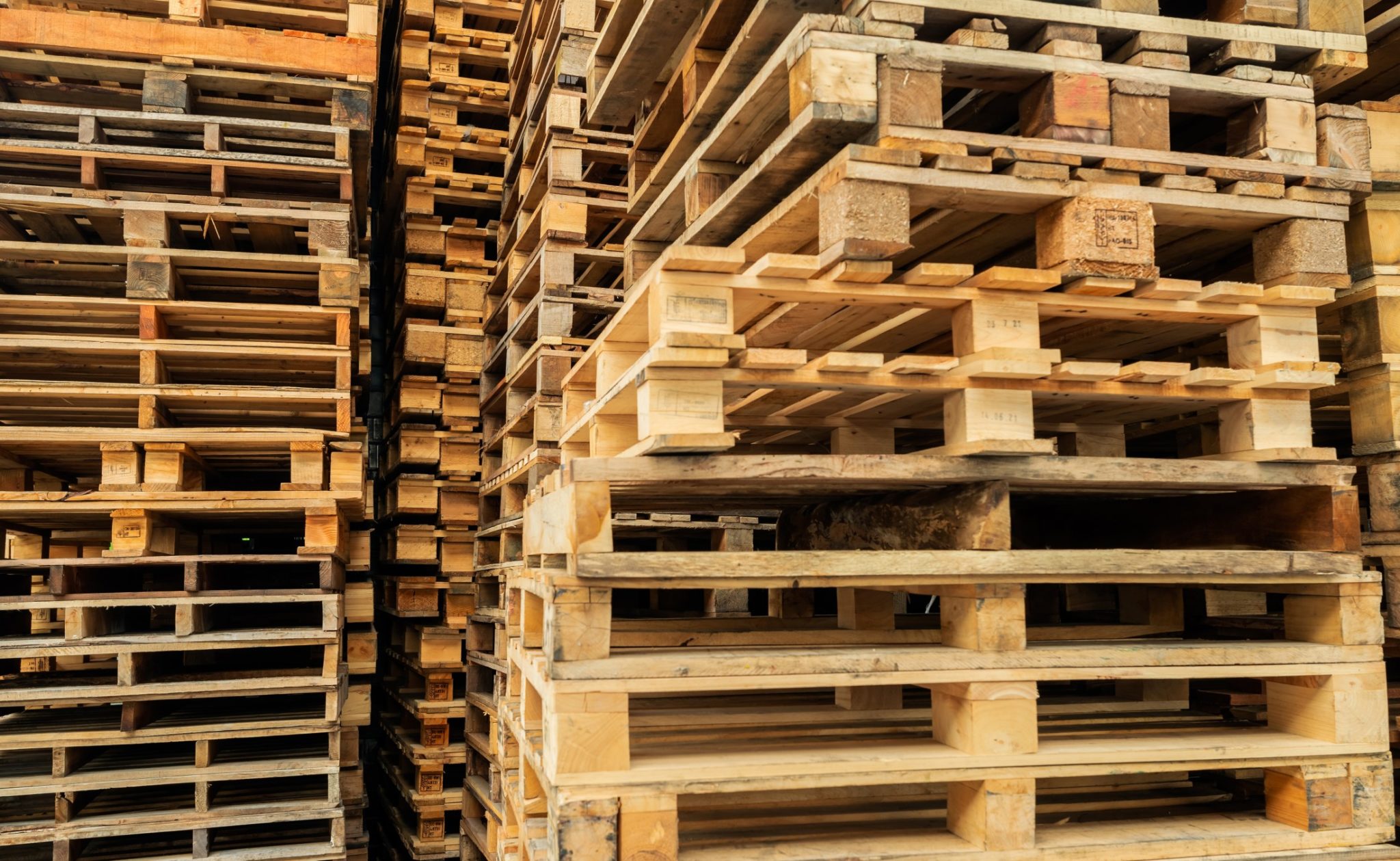 stack-of-wooden-pallet-industrwood pallet at factory warehouse cargo and shipping concept