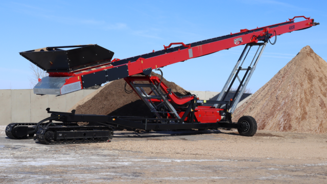 Rotochopper conveyor system piling wood waste.