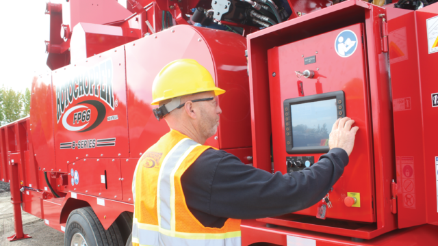 Rotochopper service technician examining Rotochopper equipment.