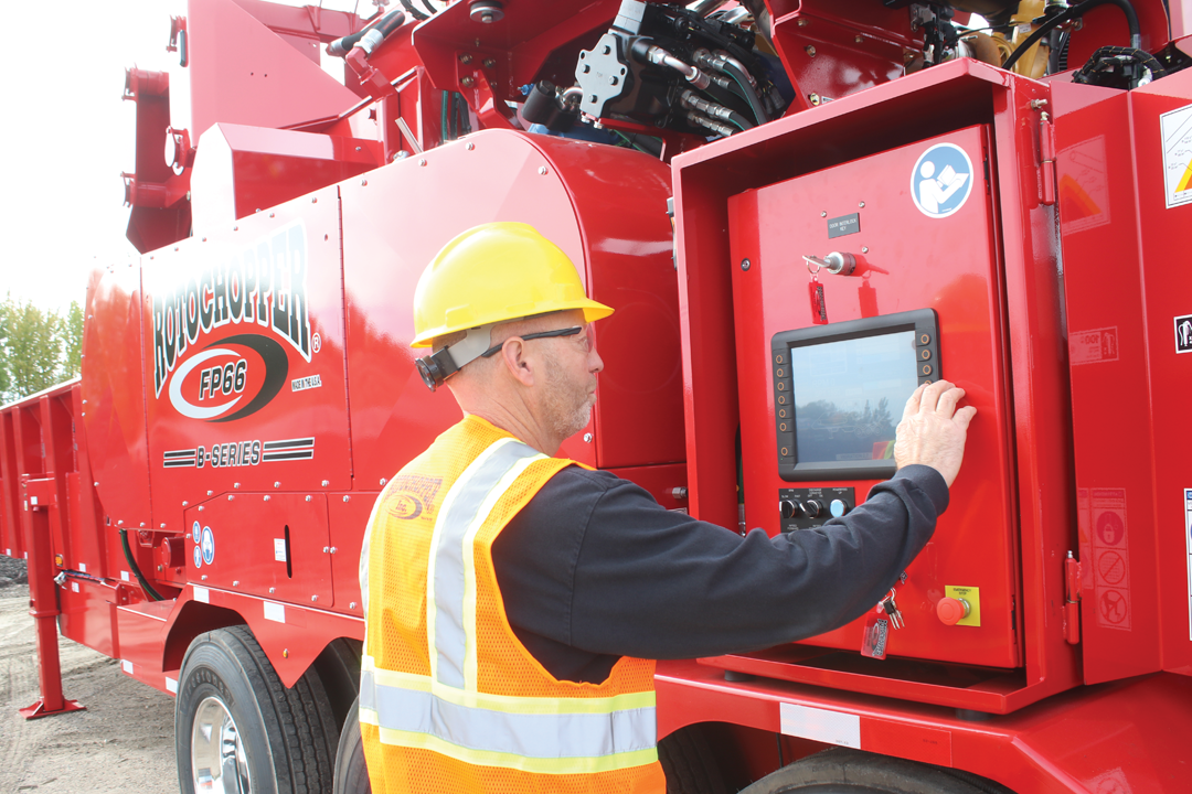 Rotochopper service technician examining Rotochopper equipment.