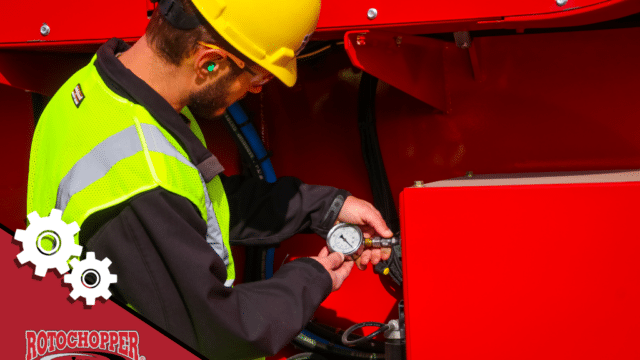A Rotochopper service technician working on a horizontal grinder