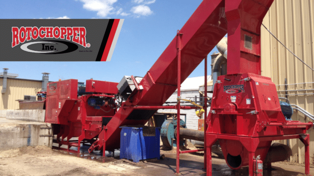 A wide-angle shot of a Rotochopper RMT Hammermill in action. At the top left of the image is Rotochopper’s logo.