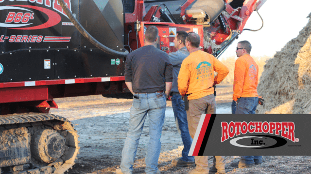 Rotochopper customers standing around Rotochopper equipment while Rotochopper sales representative shares his expertise on the horizontal grinder.