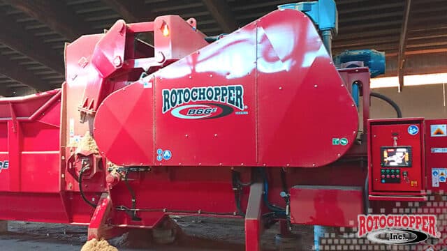 A close up shot of a Rotochopper electric horizontal grinder. The Rotochopper logo is in the bottom right corner.