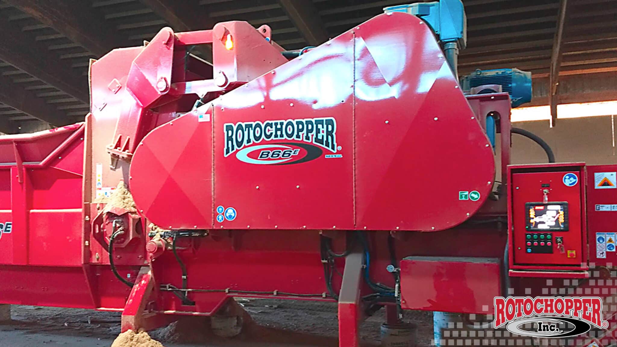 A close up shot of a Rotochopper electric horizontal grinder. The Rotochopper logo is in the bottom right corner.