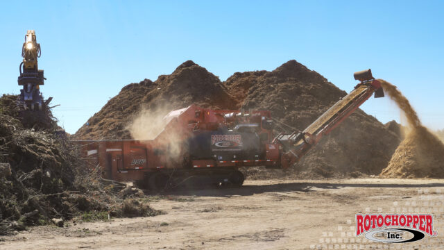 A Rotochopper B-Series high-horsepower grinder processing a large amount of wood waste.