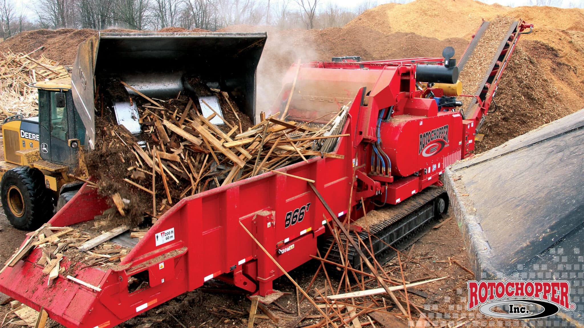 A Rotochopper B-66 grinding construction and demolition waste. The Rotochopper logo is in the bottom right corner.