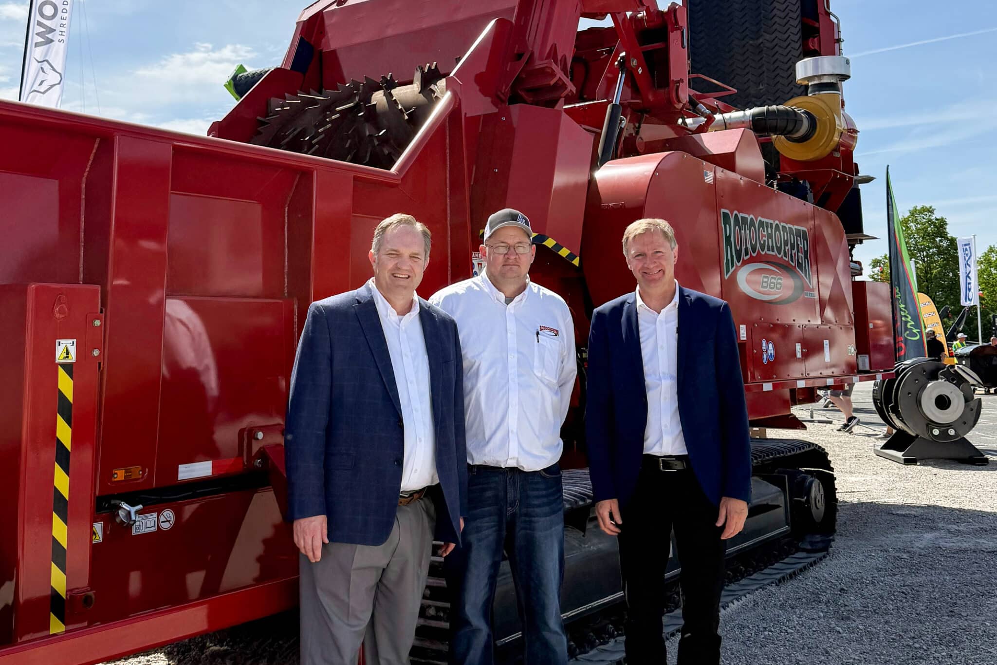 Rotochopper CEO Tosh Brinkerhoff, COO Jamey Brick, and Senior Advisor of European Operations Michael Lackner standing in front of a Rotochopper B66 horizontal grinder at IFAT Munich 2026