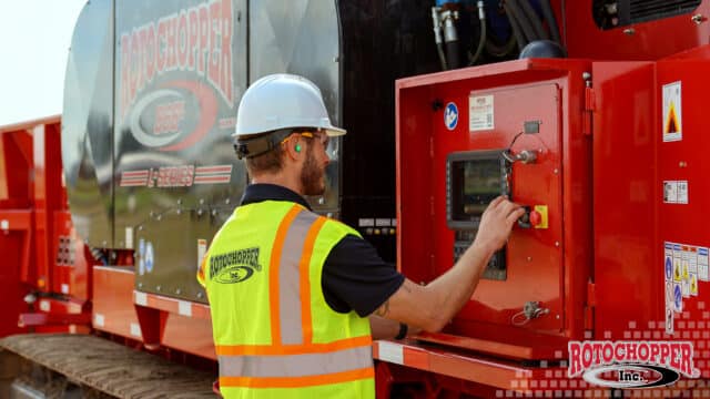 A Rotochopper service technician performs preventative maintenance on a B66L Rotochopper horizontal grinder.