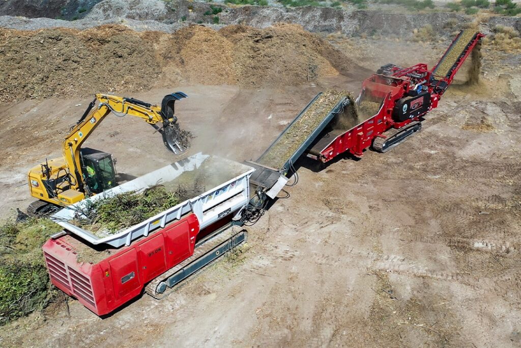 Aerial view of a Rotochopper shredder and horizontal grinder running in-line, processing material at a worksite